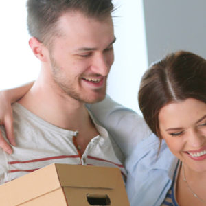 happy couple with moving boxes