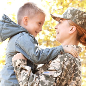 female veteran holding her son
